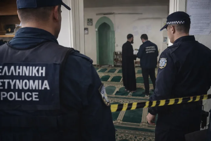Police officers conducting an on-site check related to licensing and sealing procedures for an unlicensed place of worship in Athens.