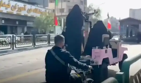 Γυναικείες μορφές με μαύρο chador πάνω σε τζιπ στην Τεχεράνη, σε εικόνα που συνδέεται με καθεστωτική προπαγάνδα και σκηνοθετημένη προβολή ισχύος